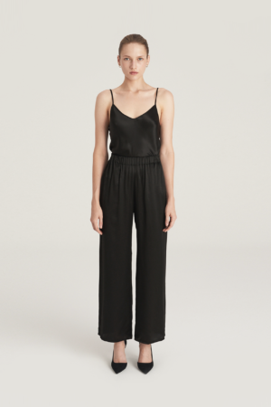 Black silk strappy V-neck top and black wide trousers
