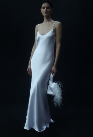 White silk satin maxi dress and white bag with feathers
